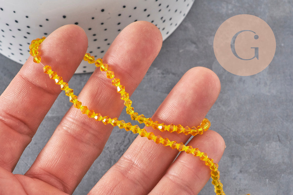 Perles toupies cristal à facette jaune 3.8x3mm, x1 fil de 32.5cm (G11343)