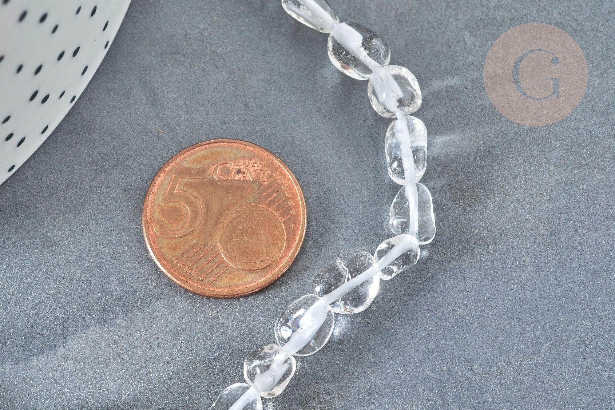 Natural rock crystal beads, oval-shaped, next to a 5-cent euro coin on a dark surface, part of a 40cm strand for DIY jewelry (G2050).